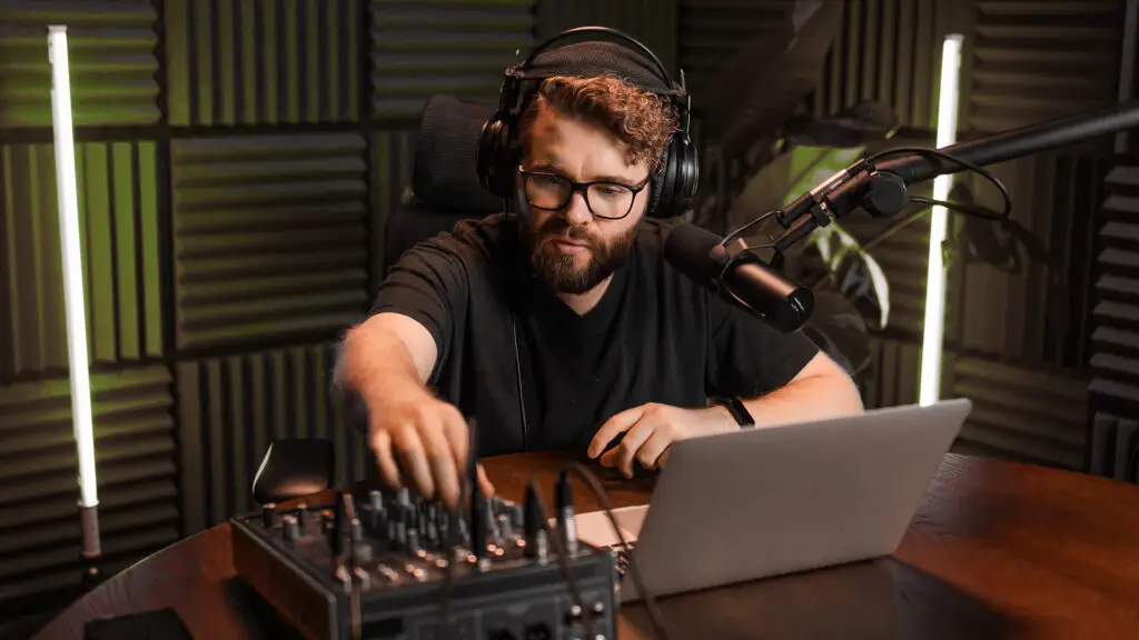 Podcaster bei der Aufnahme im Tonstudio mit Mikrofon, Kopfhörer und Mischpult – Symbolbild für Unternehmenspodcasts, produziert von der Design und IT Agentur aus Herford snutig.